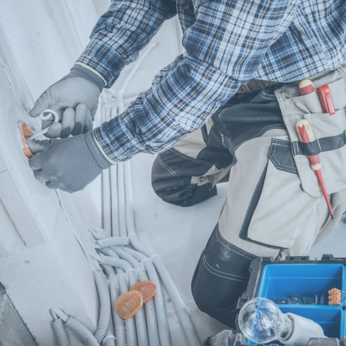 Professional building maintenance services with a technician inspecting and servicing mechanical and electrical systems to ensure safe operation, efficiency, and long-term facility performance.